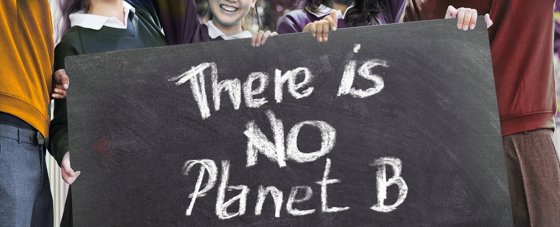 A group of protesters holding a sign